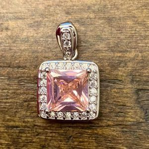 5/$25 pendant with pink-ish colored stone and diamonds in a silver setting